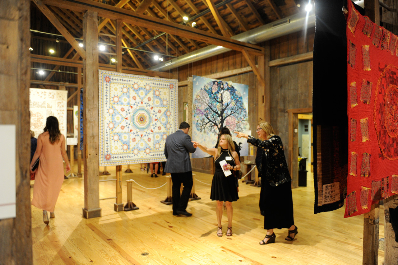 Guests admire the quilts on display