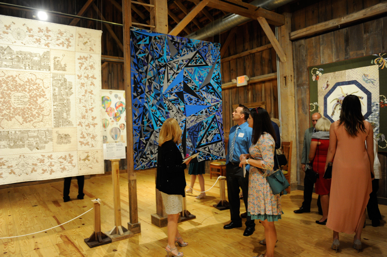 Guests admire the quilts on display